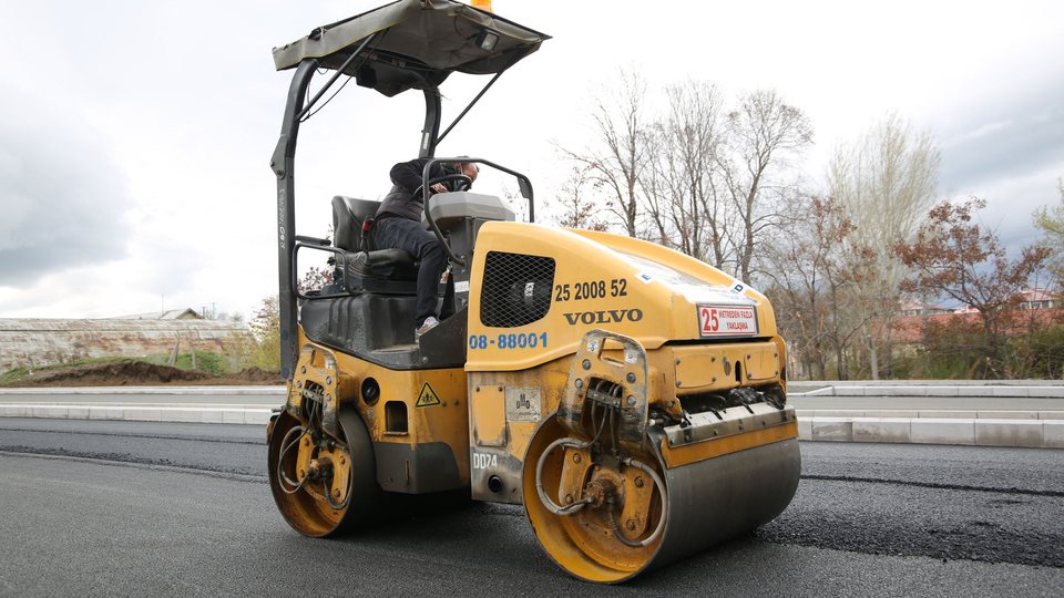 Double-drum roller compacting a freshly laid asphalt mat